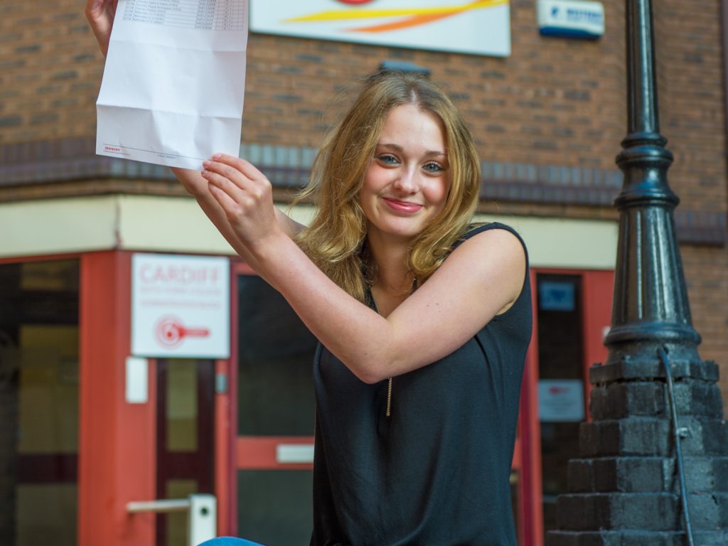 Girl holding her exam results