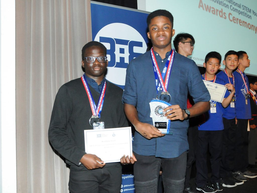 students from a private school in wales holding their awards