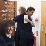 a teacher congratulating a student at a top sixth form college
