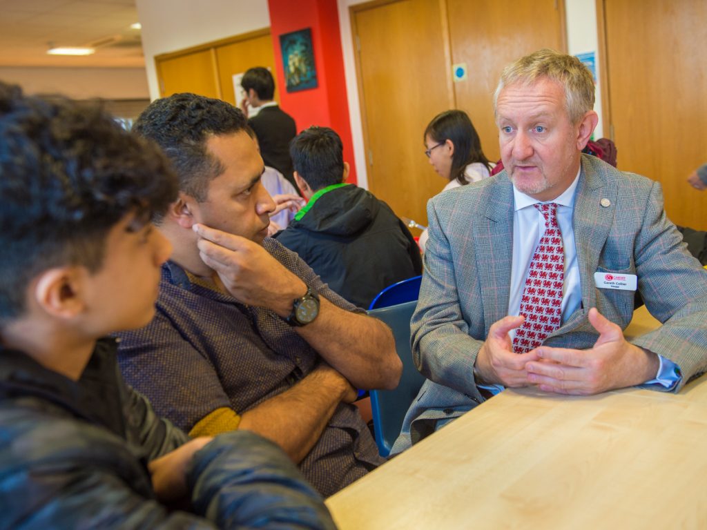 teacher talking to parent and pupil