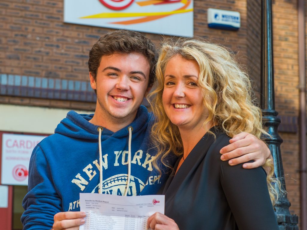 Son and Mother holding exam results