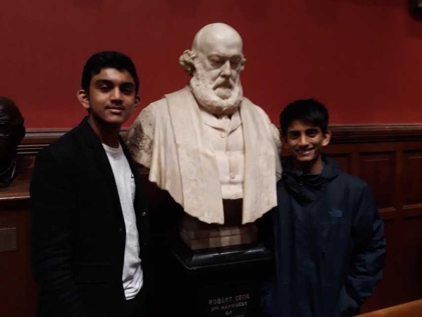 boys stood next to a statue