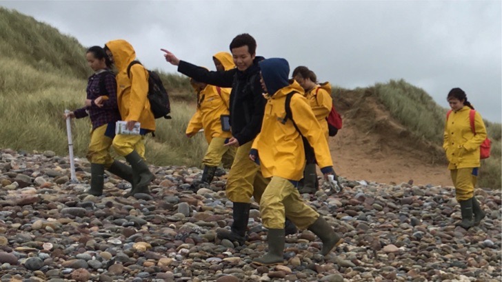 Students on a walk on the beach