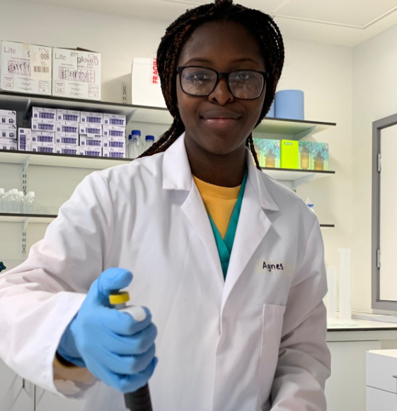 a girl from an A level college holding a test tube