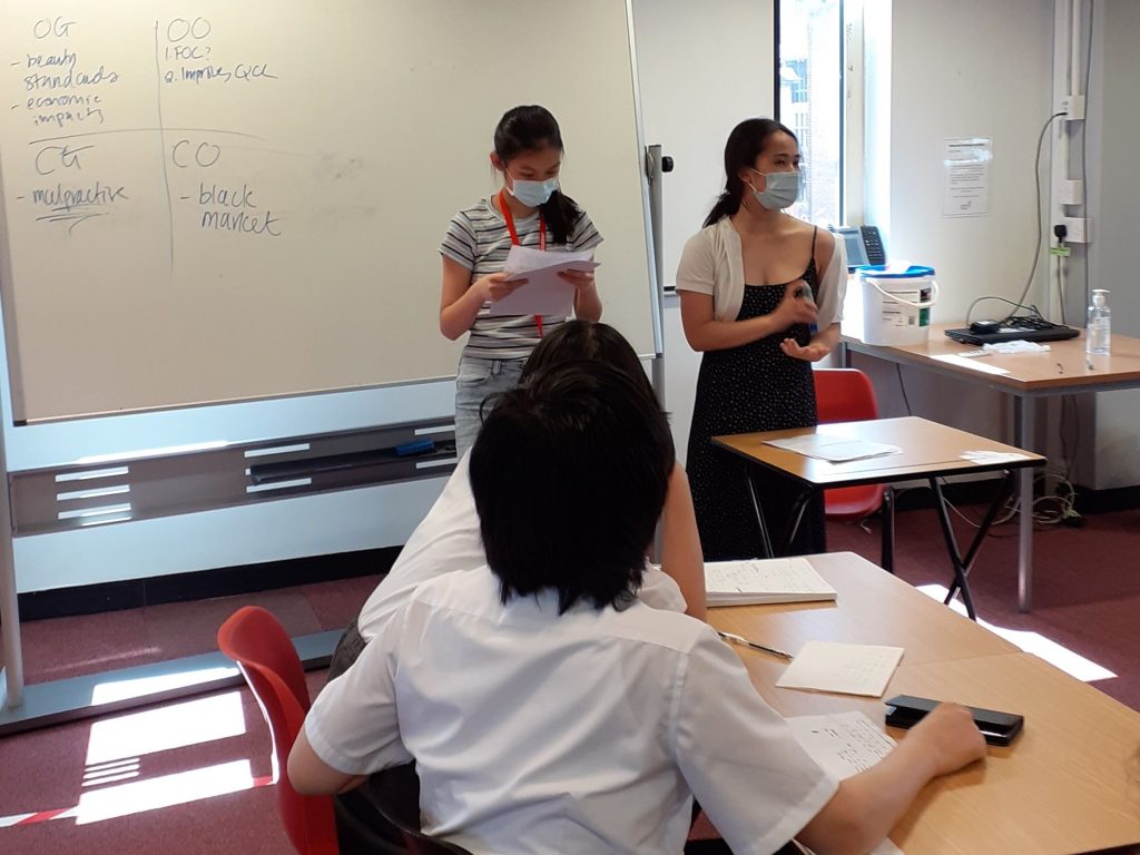 student reading off a piece of paper for a debate workshop