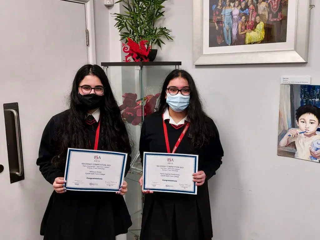 students holding up their certificates