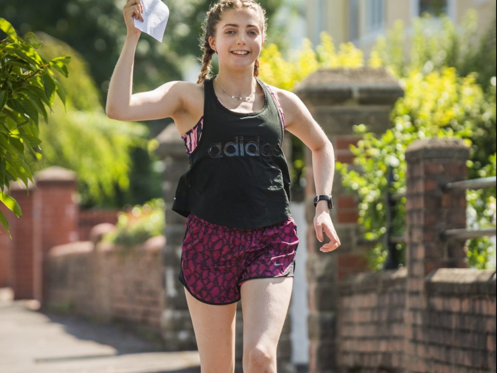 Student celebrating A Level results whilst running