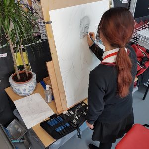 student in the middle of a sketch