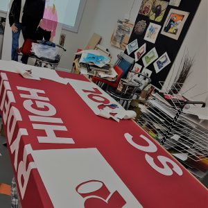 Table with red and white pieces of paper to cut up words