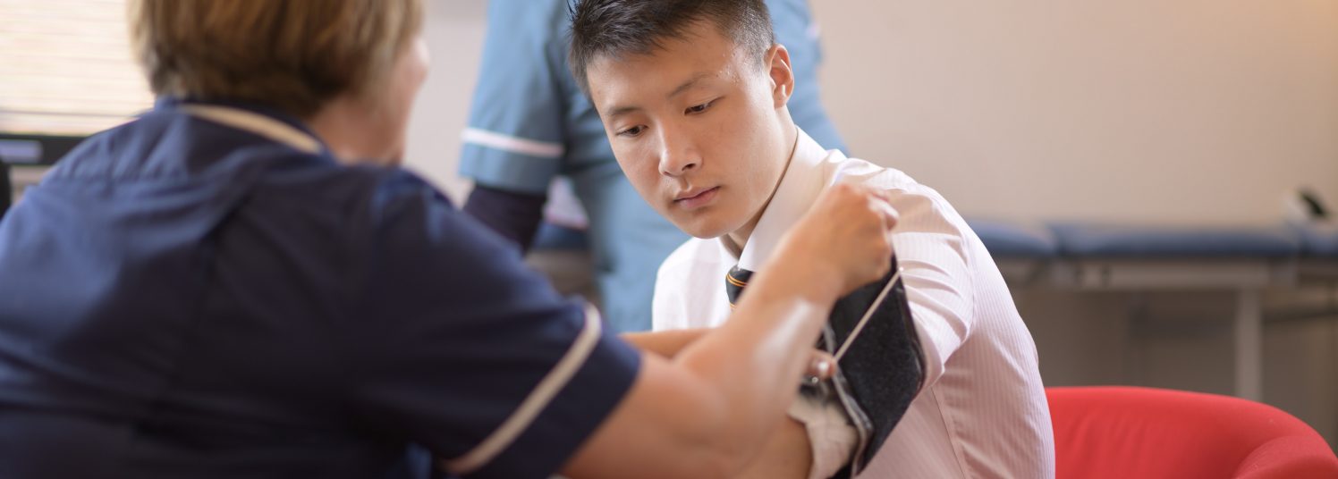 Nurse taking a students' blood pressure