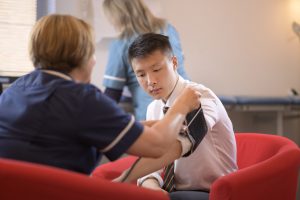 Nurse taking a students' blood pressure