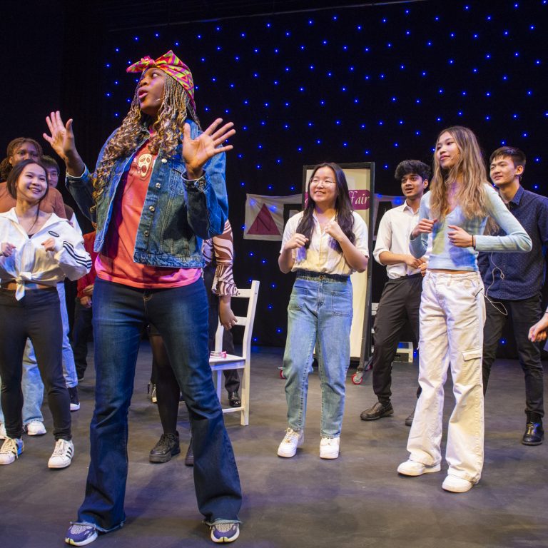 Actors dancing to the beat of the song in their recent production
