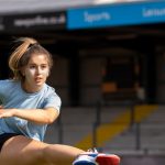 student kicking ball